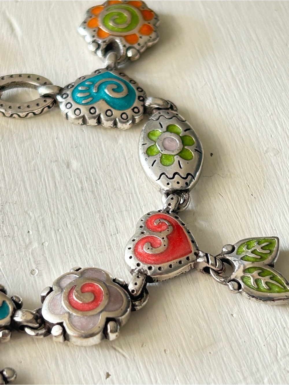 Retired Brighton charm bracelet featuring colorful enamel flower and heart charm